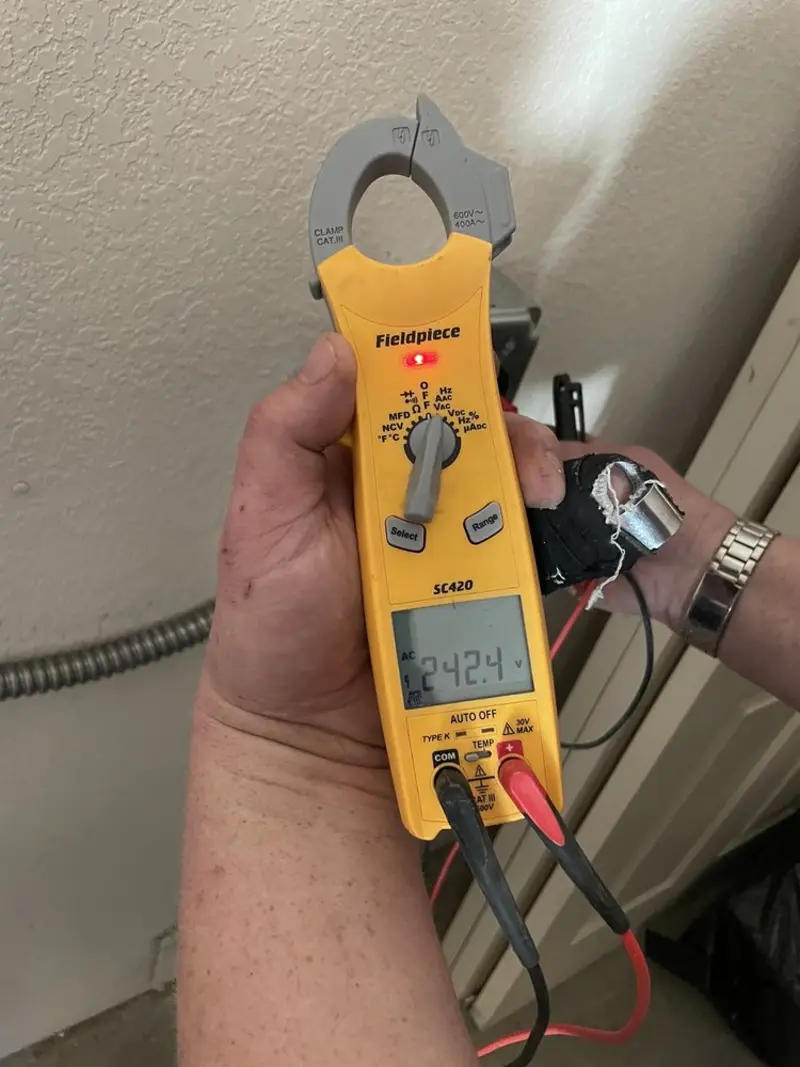 Voltage testing with clamp meter during Recessed Lighting Installation in Mayfield